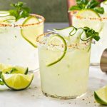 A selection of premium tequilas with fresh limes and salt, perfect for crafting the ultimate margarita cocktail