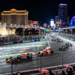 Formula 1 cars racing past Las Vegas Strip hotels at night during the Heineken Las Vegas Grand Prix