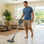 Man using a budget cordless vacuum on bright tile floors in a Florida living room.