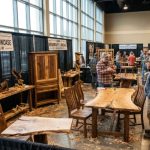 Woodworkers displaying handcrafted furniture and carvings at the NWA Woodworker's Showcase 2027 in Saratoga Springs, New York